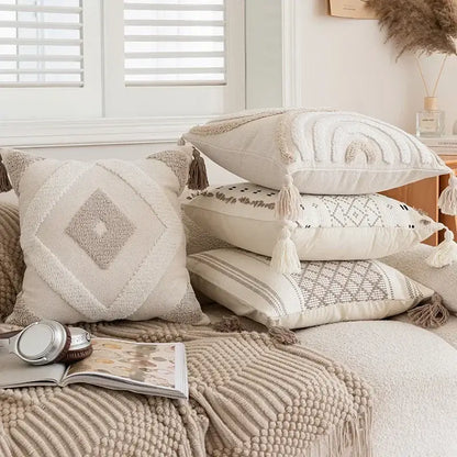 Stack of cream and beige geometric embroidered crocheted pillow covers with tassels for living room decorbites decor