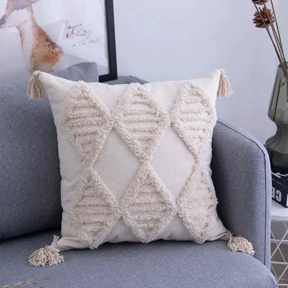 Cream cushion cover with geometric embroidery featuring textured diamond patterns and tassels for living room decorbites