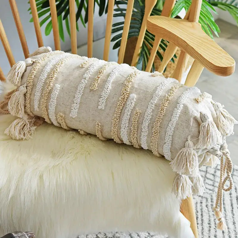 Beige cylindrical cushion cover with textured woven stripes tassels featuring decorbites geometric embroidery decor