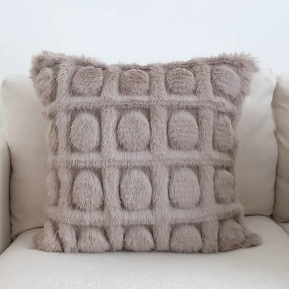 A cream geometric faux fur pillow case with taupe textured embossed grid of rounded raised circles for decorbites