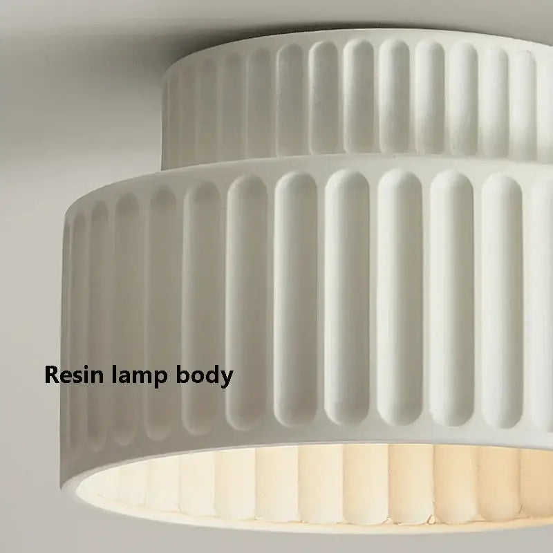 White resin lamp body with vertical fluted ridges in a cream green led chandelier lamp for dining room lighting
