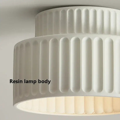 White resin lamp body with vertical fluted ridges in a cream green led chandelier lamp for dining room lighting