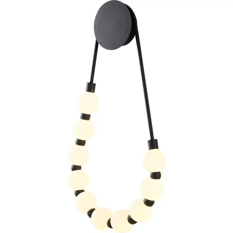 Black wall lamp with circular base and frosted glass globe beads in decorbites cream italian style bedroom sconce