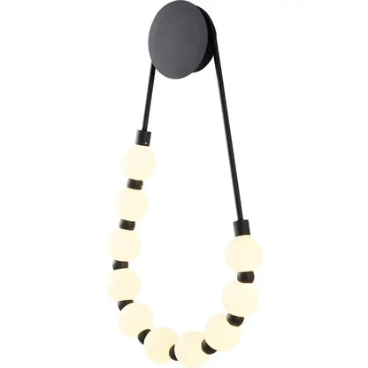 Black wall lamp with circular base and frosted glass globe beads in decorbites cream italian style bedroom sconce