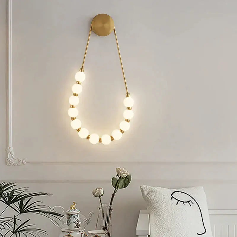 Cream italian style gold globe wall lamp with circular glowing spherical bulbs for bedroom decorbites cream italian sconce