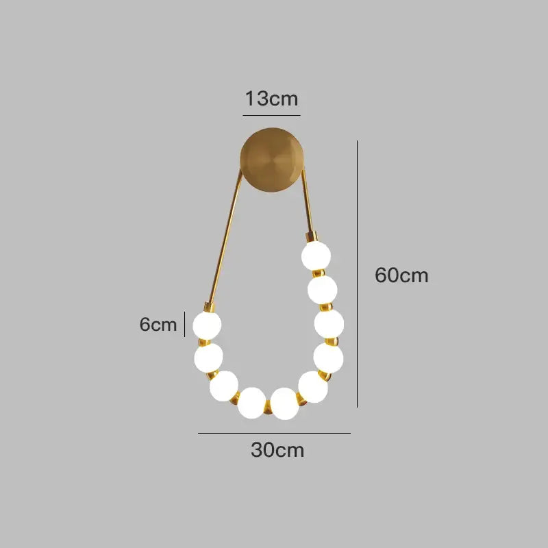 Gold-toned cream italian style wall lamp with nine glowing white globes and circular mounting plate for bedroom decorbites cream italian