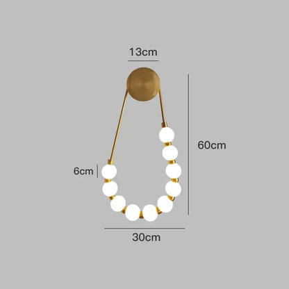 Gold-toned cream italian style wall lamp with nine glowing white globes and circular mounting plate for bedroom decorbites cream italian