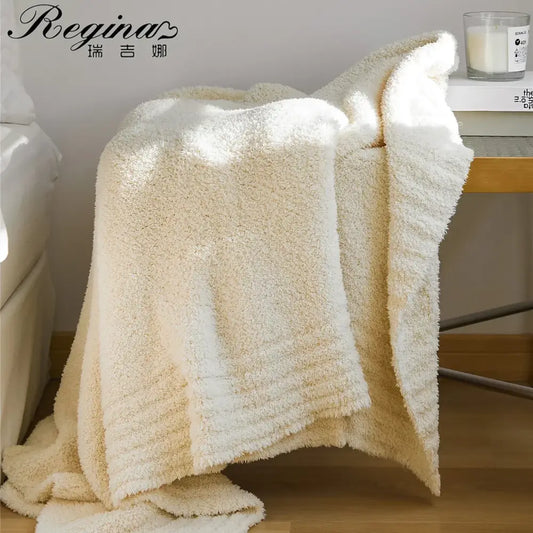 Cream knitted throw blanket with plush microfiber material ribbed edge detailing and soft fluffy texture for bedroom use