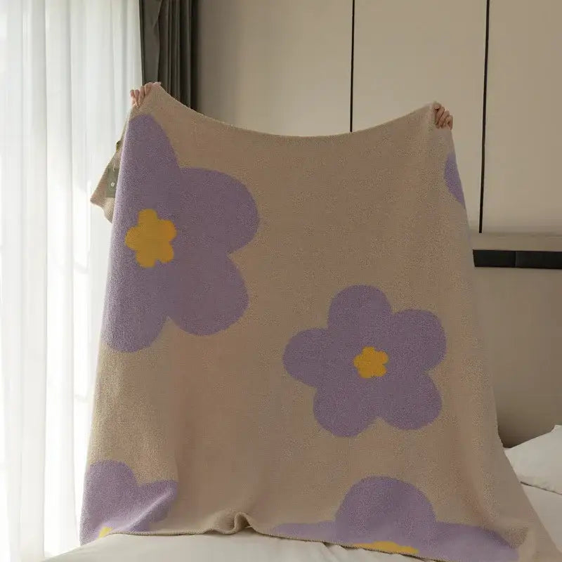 A soft beige cream korean kawaii flower blanket with oversized purple flowers and cloud patterns for plush decorbites decor