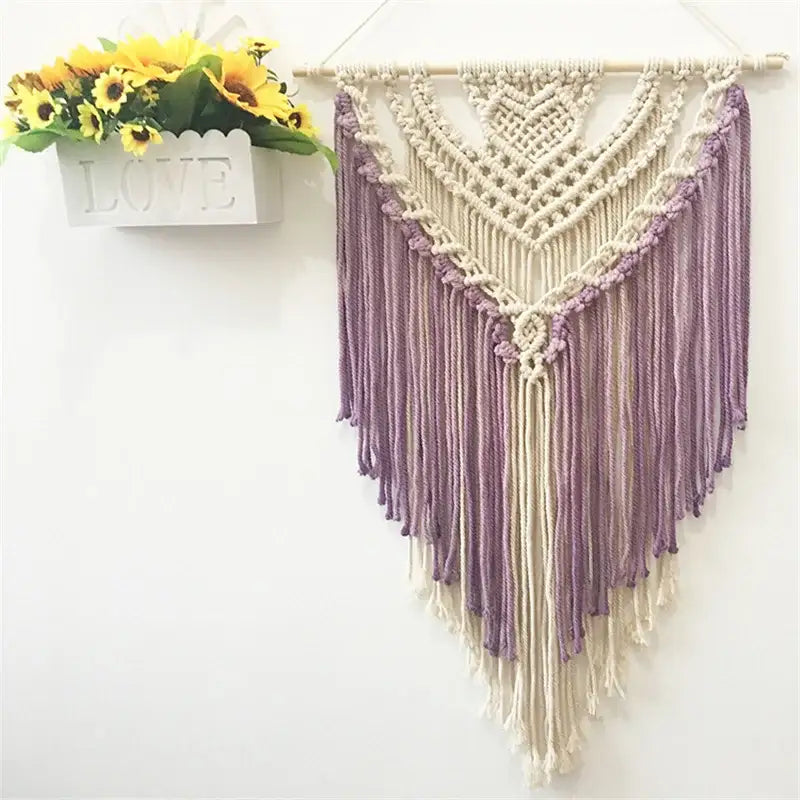 A cream and lavender macrame wall hanging made of colorful cotton for living room decor by decorbites