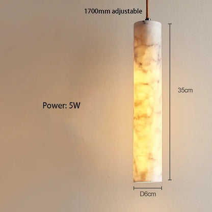 Cream marble cylinder pendant light with warm amber glowing finish for luxury bedroom and bar counter decorbites cream marble