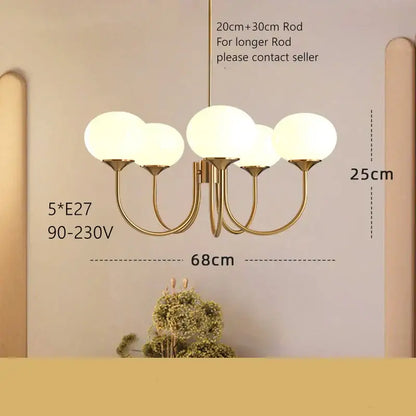 Gold-toned modern pendant light with five frosted glass globes for decorbites cream pink bedroom decor