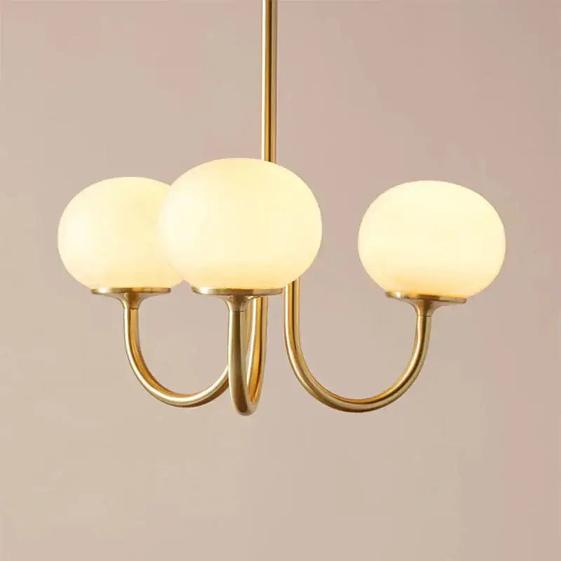 Gold-toned pendant light with three frosted glass globes for cream pink bedroom decorbites cream pink lighting