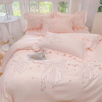 Pastel pink satin duvet set featuring ice silk embroidered ruffles and delicate bows for bedroom bedding