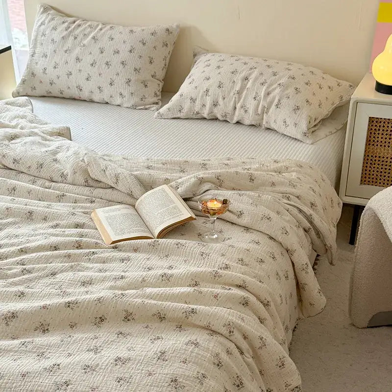 Cream cotton muslin quilt set with cream polka dot floral prints featuring delicate gray flowers for bedroom bedding