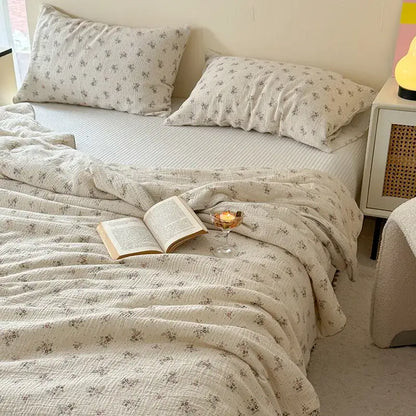 Cream cotton muslin quilt set with cream polka dot floral prints featuring delicate gray flowers for bedroom bedding