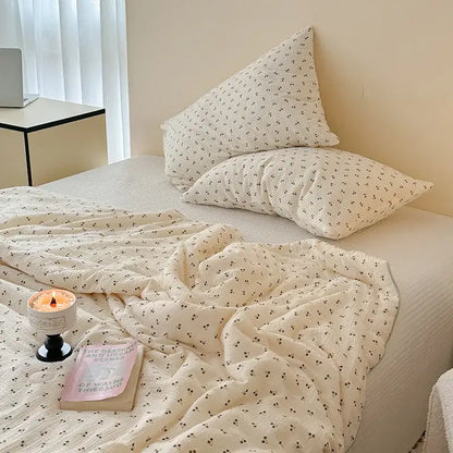 Cream quilt set with quilted polka dot floral design and delicate black cherry blossom pattern for bedroom bedding