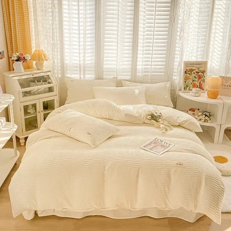 Cream ribbed bubble yarn cotton duvet cover set with ribbed texture and subtle embroidered branding on pillows