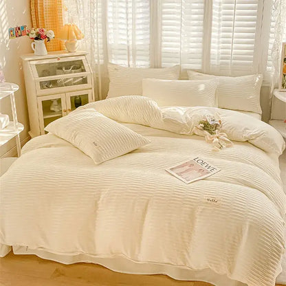 Cream ribbed bubble yarn cotton duvet cover set with a soft textured finish and subtle embroidered branding