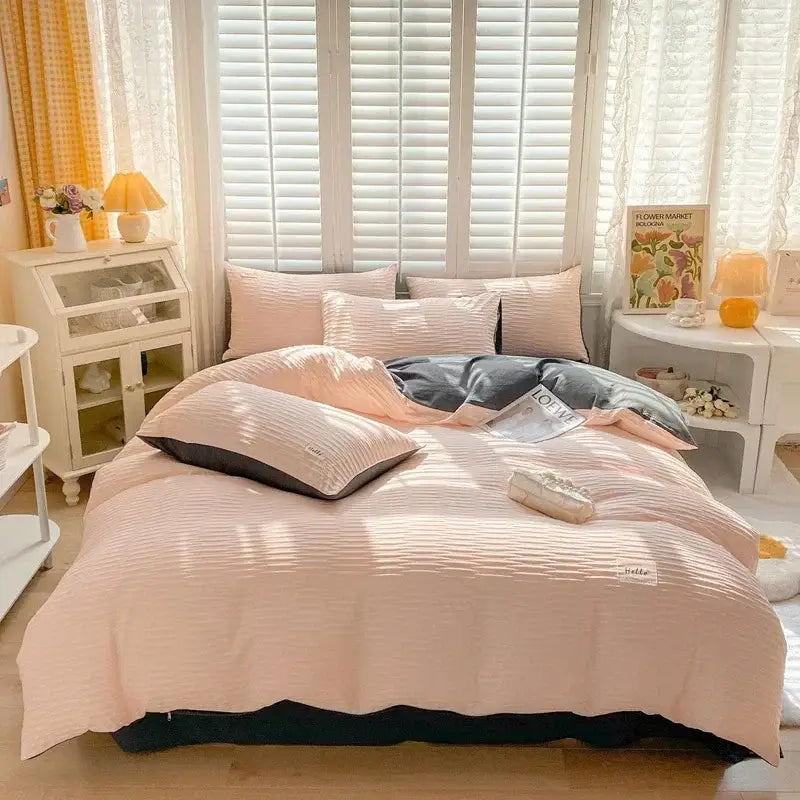 Soft blush pink ribbed bubble yarn duvet cover set with dark gray underside and matching pillows for bedroom bedding