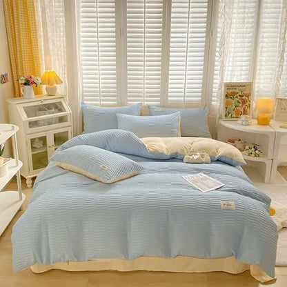Light blue ribbed cotton bedding set with cream accents featuring decorbites bubble yarn fabric and small fabric labels