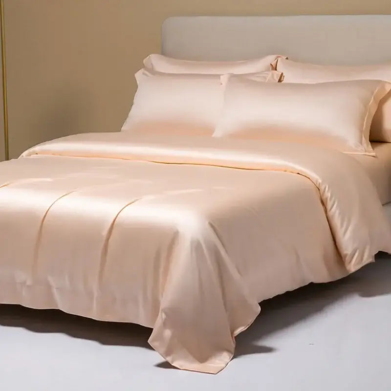 A luxurious peach satin bedding set with a smooth glossy finish made from decorbites 120s natural fabric for cooling comfort