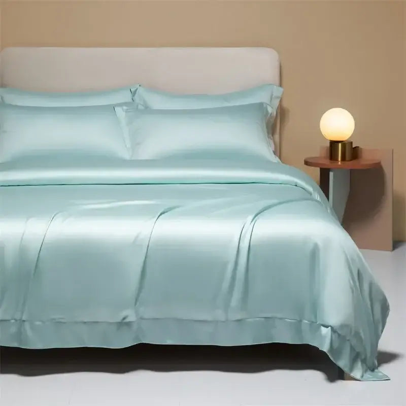 A smooth light blue satin bedding set with matching duvet and pillows made from decorbites 120s natural fabric
