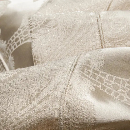 Delicate cream-colored lace fabric with intricate patterns and subtle shimmer in decorbites jacquard egyptian cotton bedding set