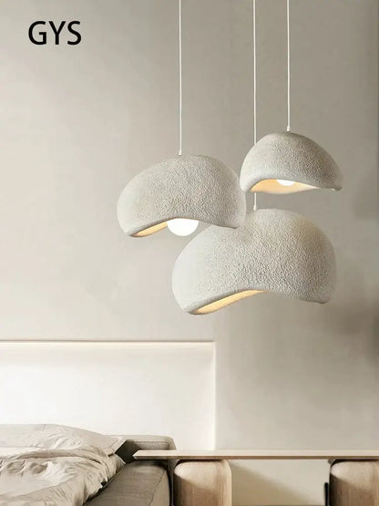 Three off-white textured cream style cloud pendant lamps hanging as dining room decorbites cream style lighting