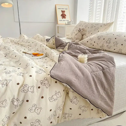 Cream teddy bear breathable double gauze quilt with black and brown bears paired with soft gray fleece blanket