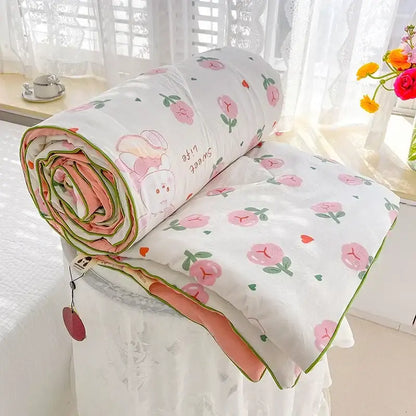 A soft white breathable double gauze quilt with pink peach pattern and coral lining for bedroom decorbites bedding