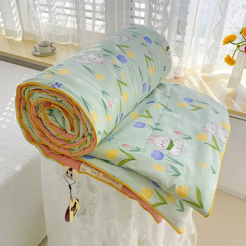 Cream teddy bear double layered soya fibre quilt in soft mint green with bunny and tulip pattern and orange yellow binding