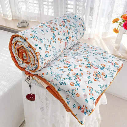 Cream teddy bear double layered soya fibre quilt with white floral pattern and orange border for bedroom comforter use