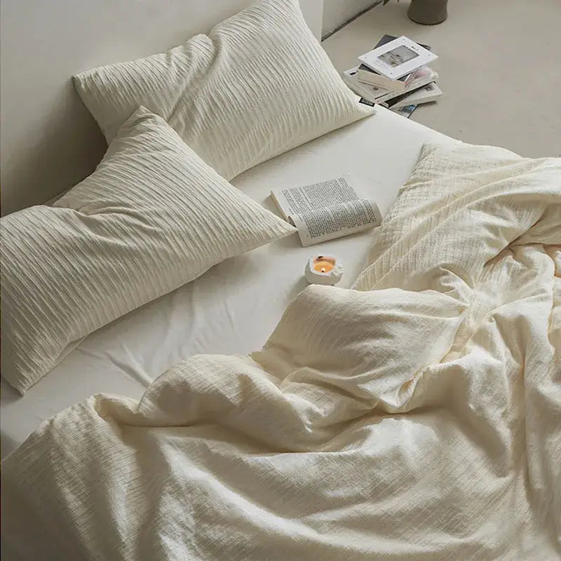 Cream textured cotton foam yarn bedding set featuring cream pillowcases with a subtle ribbed pattern for bedroom use