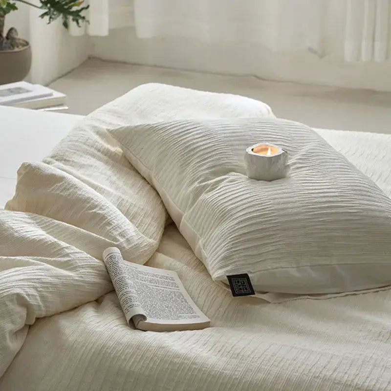 Cream textured cotton foam yarn bedding set featuring a ribbed duvet and a cream-colored textured pillow with black tag
