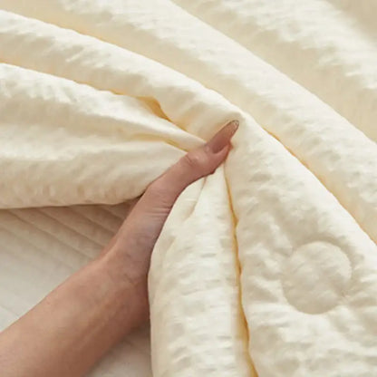 Cream textured ice cream air bubble summer quilt with soft quilted surface and subtle stitching by decorbites