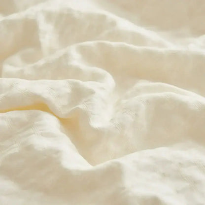 Cream textured ice cream air bubble summer quilt made of soft off-white linen fabric with subtle textured weave by decorbites