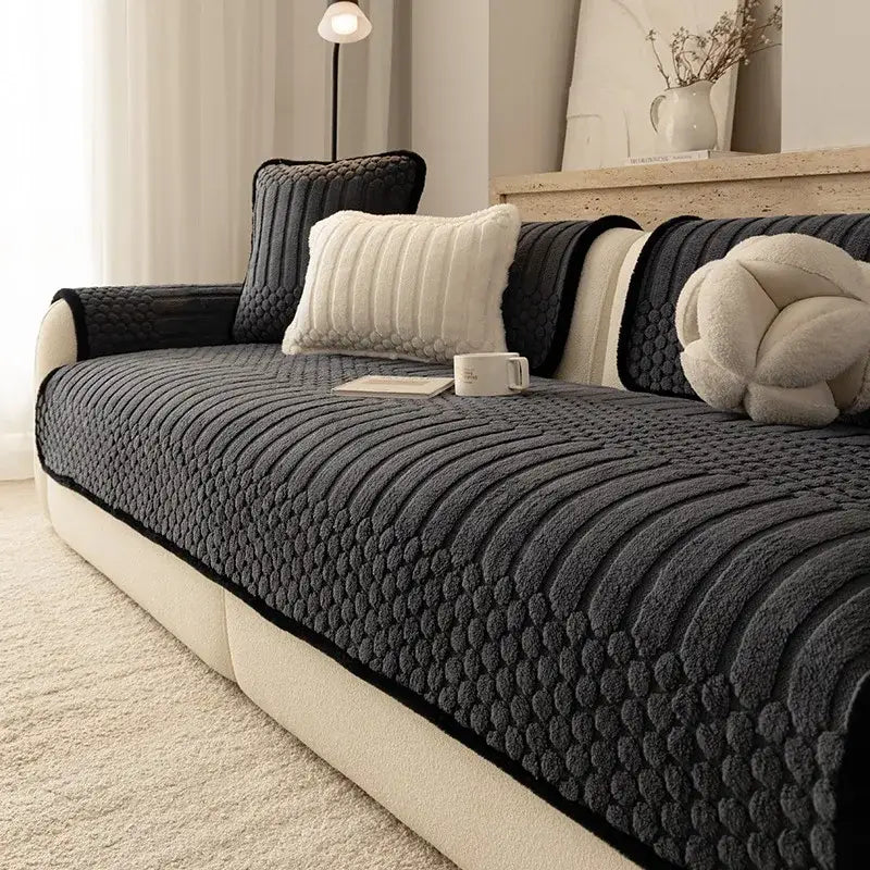 Dark gray textured jacquard knit couch cover with quilted pattern and black trim for living room sofa protection