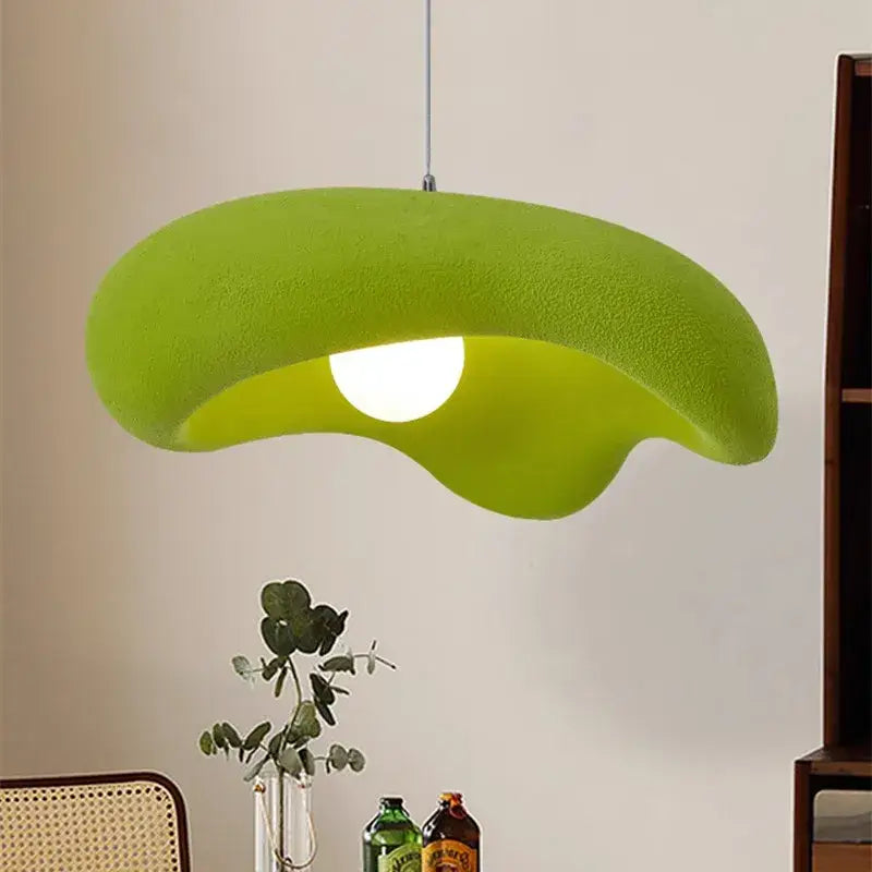 A vibrant lime green plush textured pendant light with a creamy style resin leaf shape for dining room use