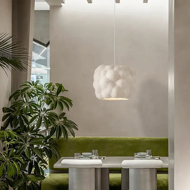 A creamy style pendant white cloud pendant light with textured surface hanging from bedroom ceiling from Decorbites