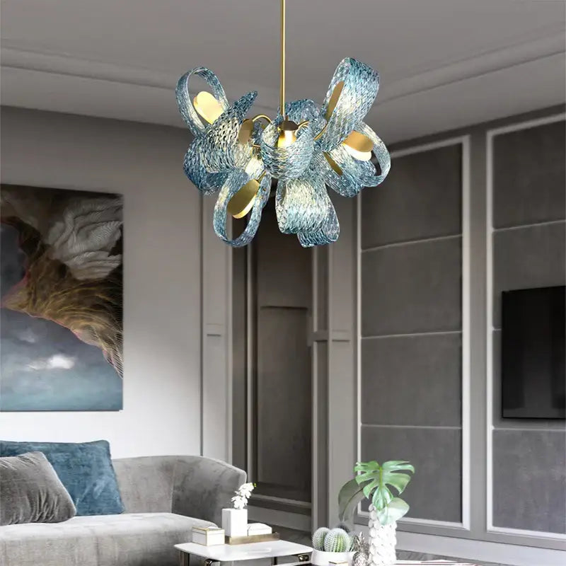 A modern blue glass pendant light with woven petal design and gold accents for luxury decorbites bedroom decor