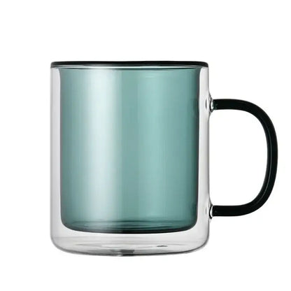 A sleek double-walled glass whiskey wine glass tumbler with teal interior and black rim and handle for dining room use