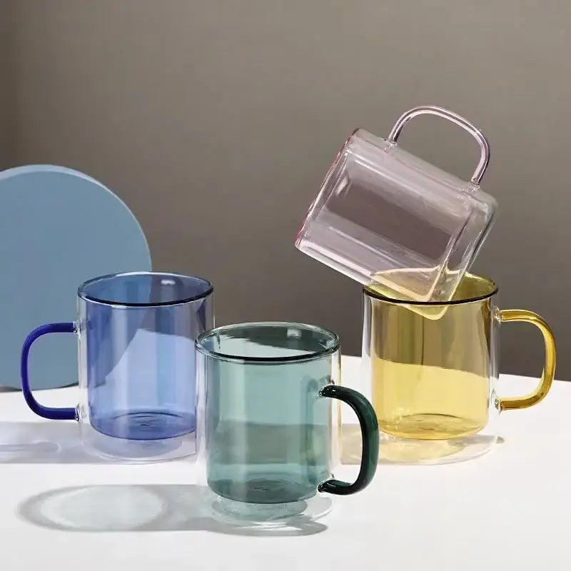 Clear glass whiskey wine glass tumblers with blue green and yellow handles for creative dining room use