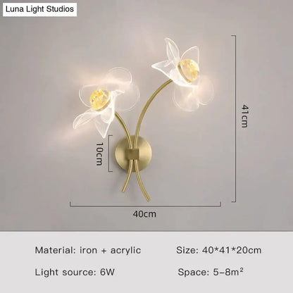 Creative floral decorative gold led wall lamp with brass-toned sconce and translucent white acrylic flowers in bedroom use