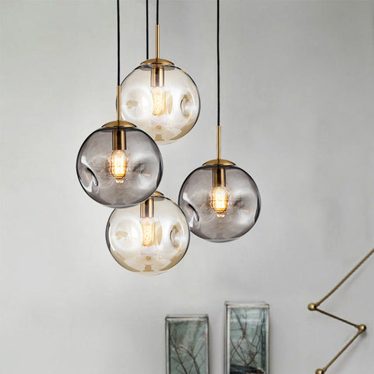 Modern creative glass chandelier with smoky gray globe, gold accents, black cords, and led lamp for restaurant window use