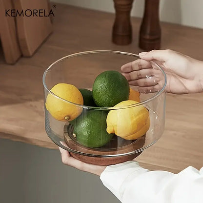 Clear glass fruit bowl with wooden base holding yellow lemons and green limes for decorbites creative glass dining room use