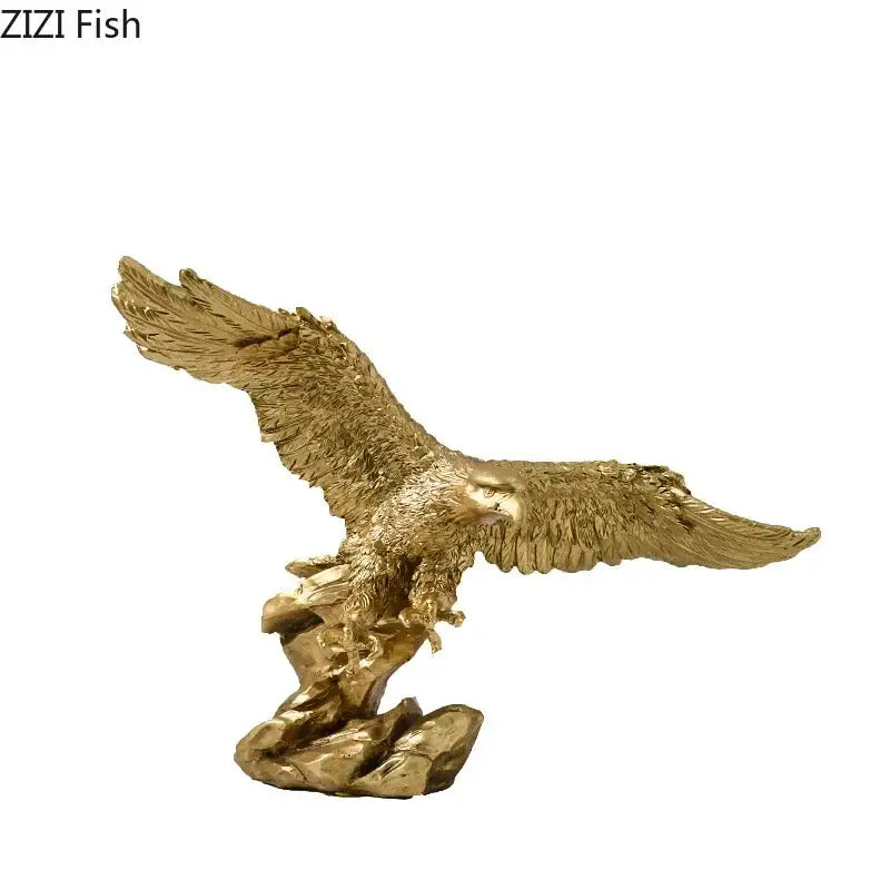 Creative golden flying eagle resin desk decoration with detailed feather texture perched on a rocky base sculpture