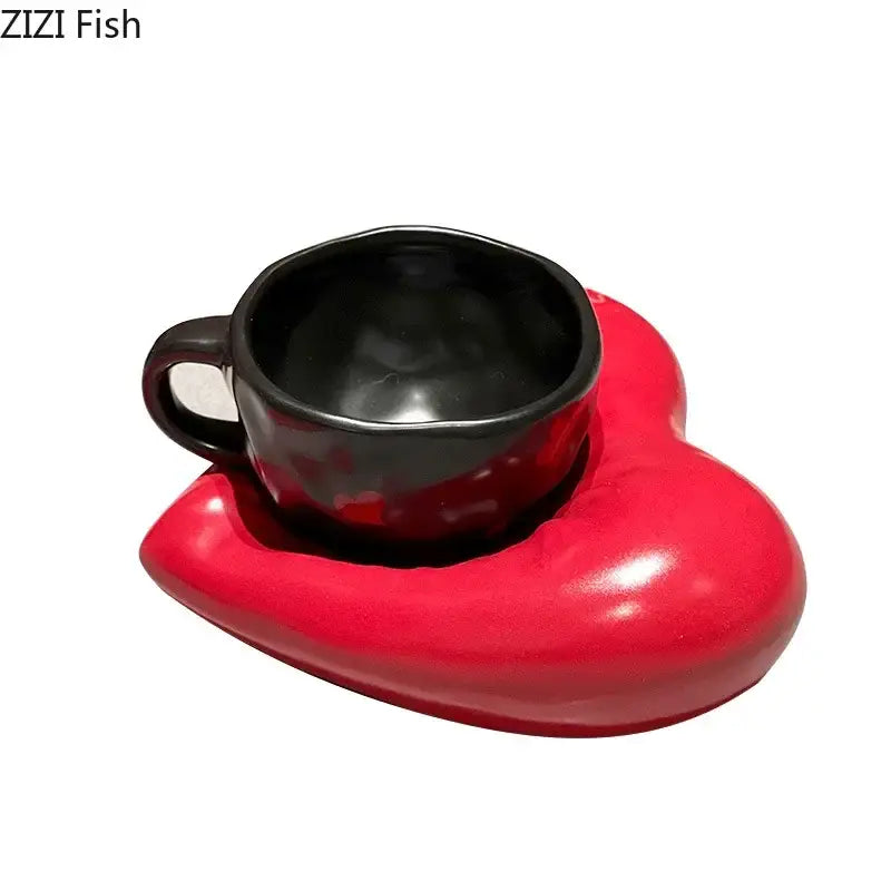 A glossy black ceramic creative heart porcelain coffee mug with matching handle on a red heart porcelain saucer decorbites creative heart