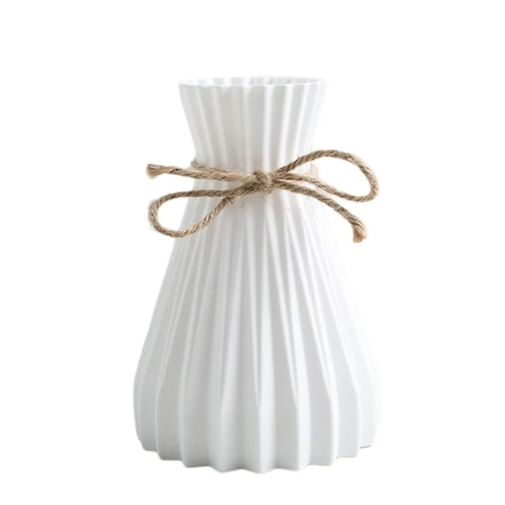 White ceramic flower bottle type vase with vertical ridges and natural twine bow for dry flower bottle display