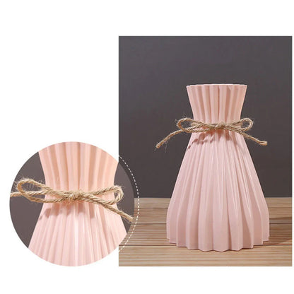 A blush pink pleated ceramic flower bottle type with rustic twine bow ideal as a modern dry flower bottle